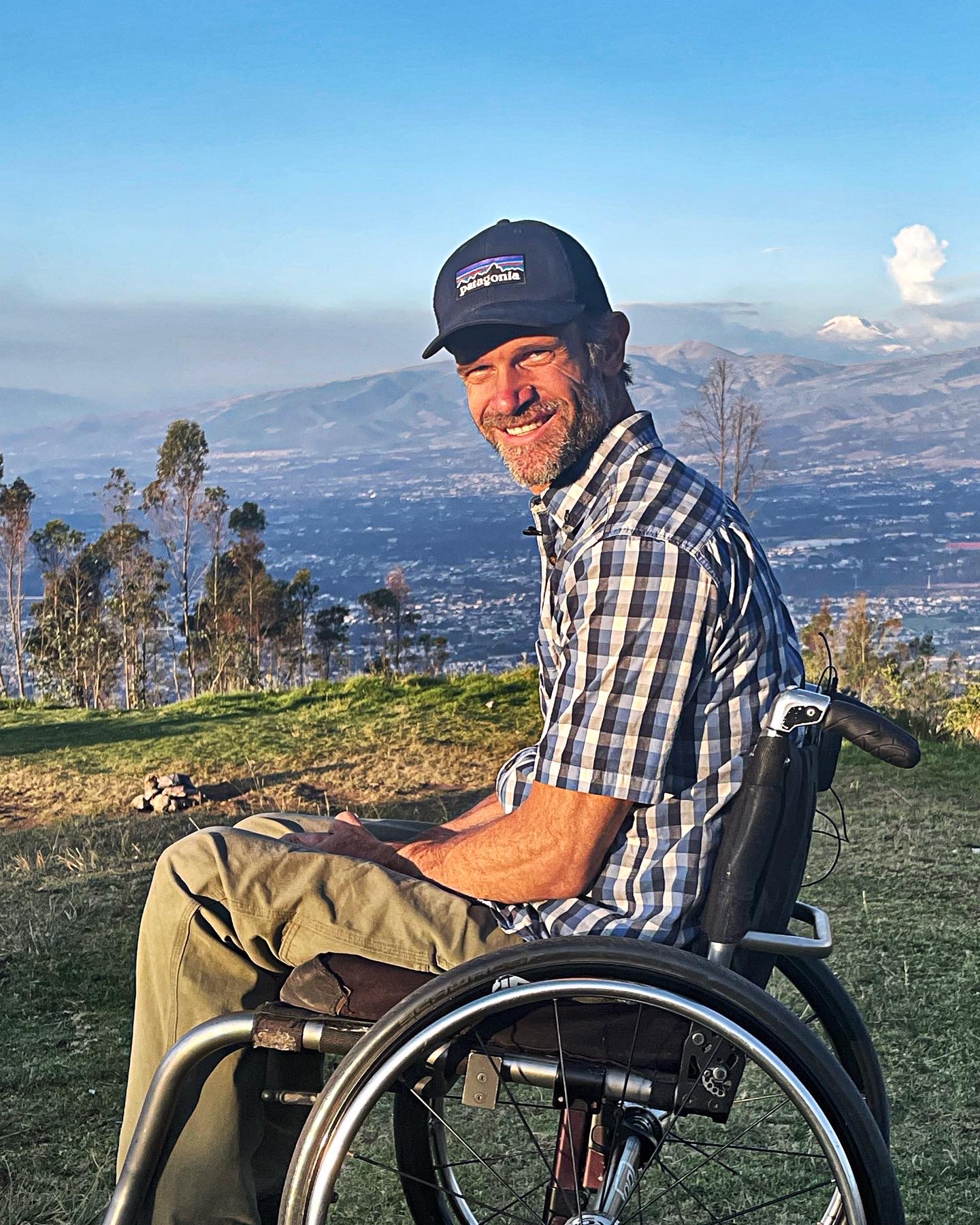 Zuko Carrasco smiling at a viewpoint overlooking Quito