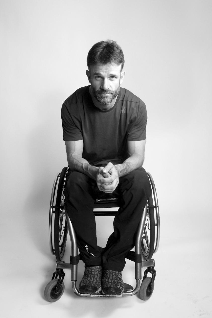 Black and white portrait of Zuko Carrasco in his wheelchair